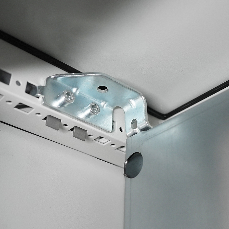 Close-up of galvanized ceiling corner bracket attached to perforated metal framing channel.