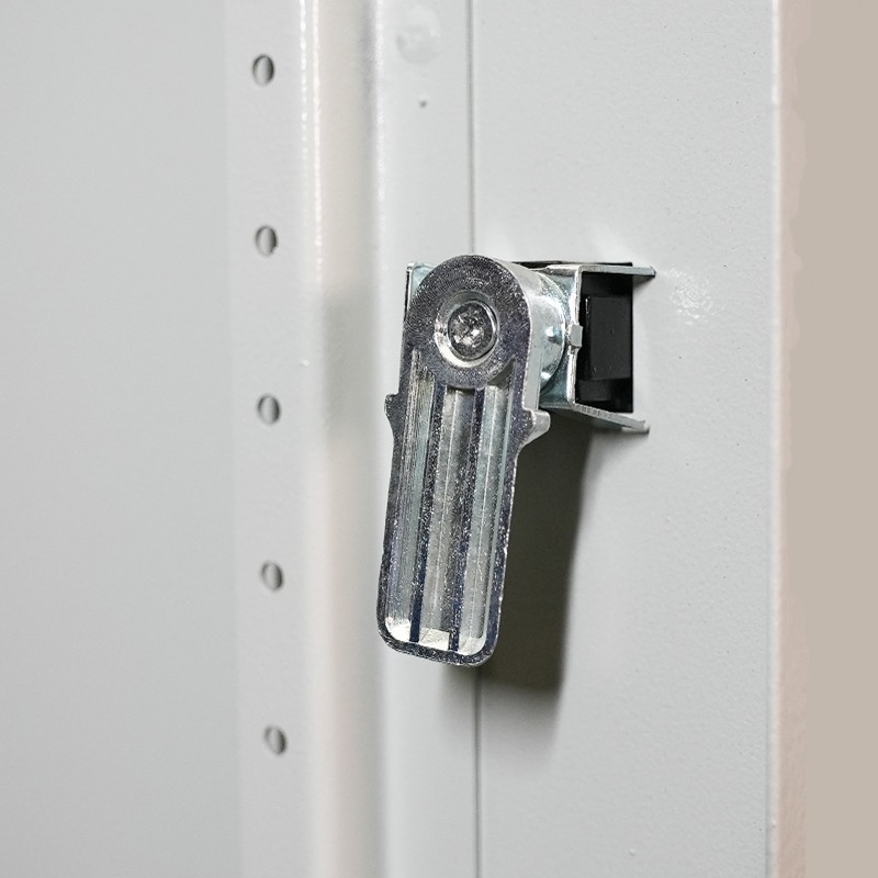 Close-up of silver cabinet latch and catch on white metal door frame