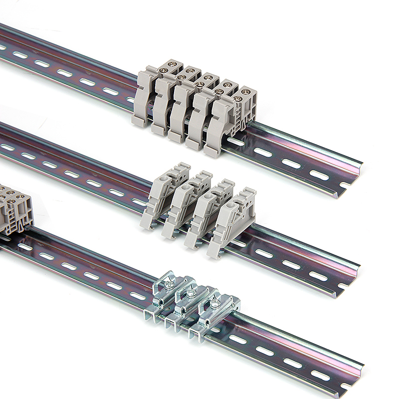 Three DIN rails with beige and silver electrical terminal blocks mounted in rows.