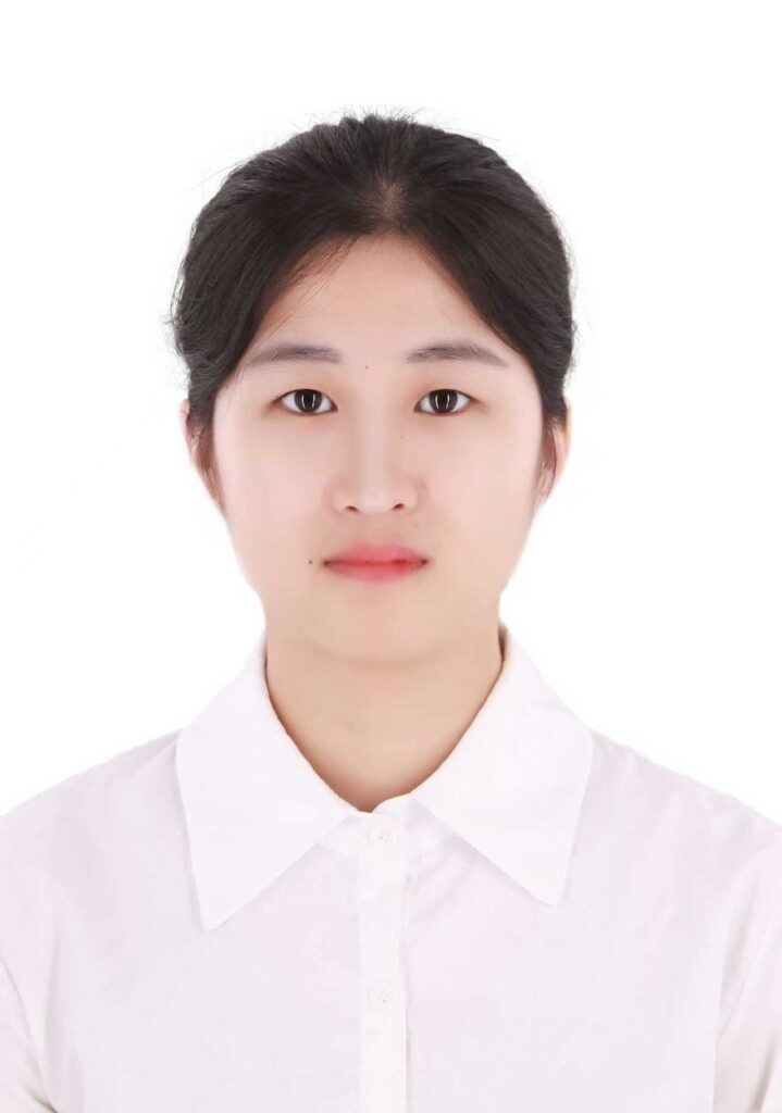 Passport-style headshot of a woman in a white collared shirt on a white background.
