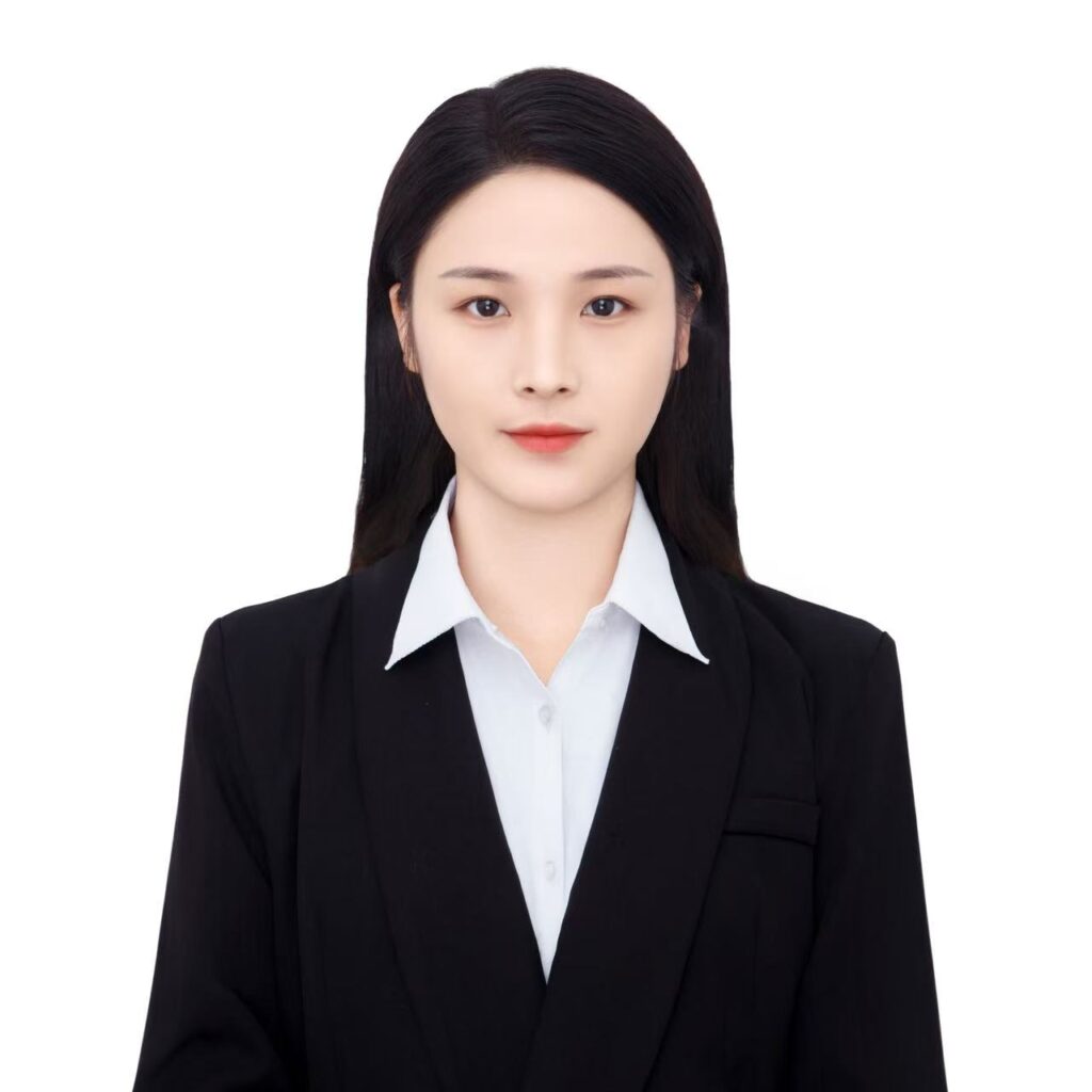 Professional business headshot of a woman in a black blazer against a white background.
