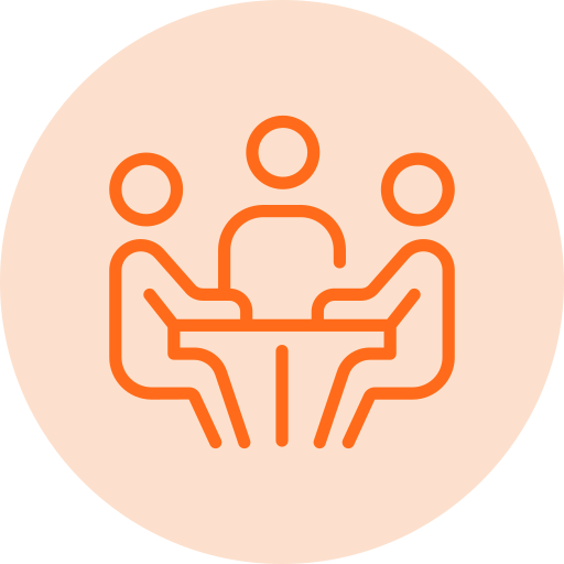 Three-person team meeting icon with people seated around a conference table