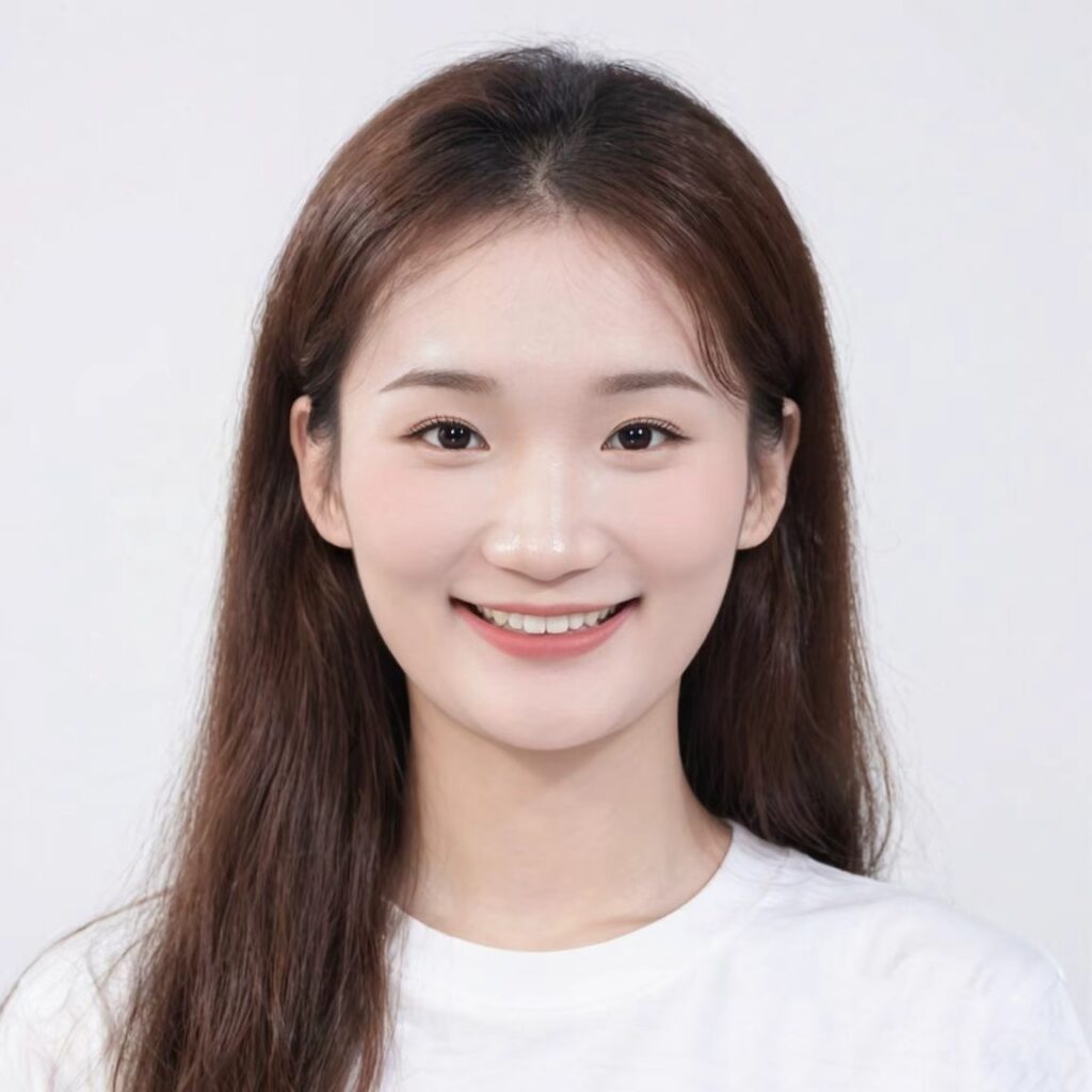 Smiling young woman professional headshot, white shirt, light background