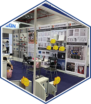 Industrial trade show booth with truss frame, product display walls, shelves, and meeting table