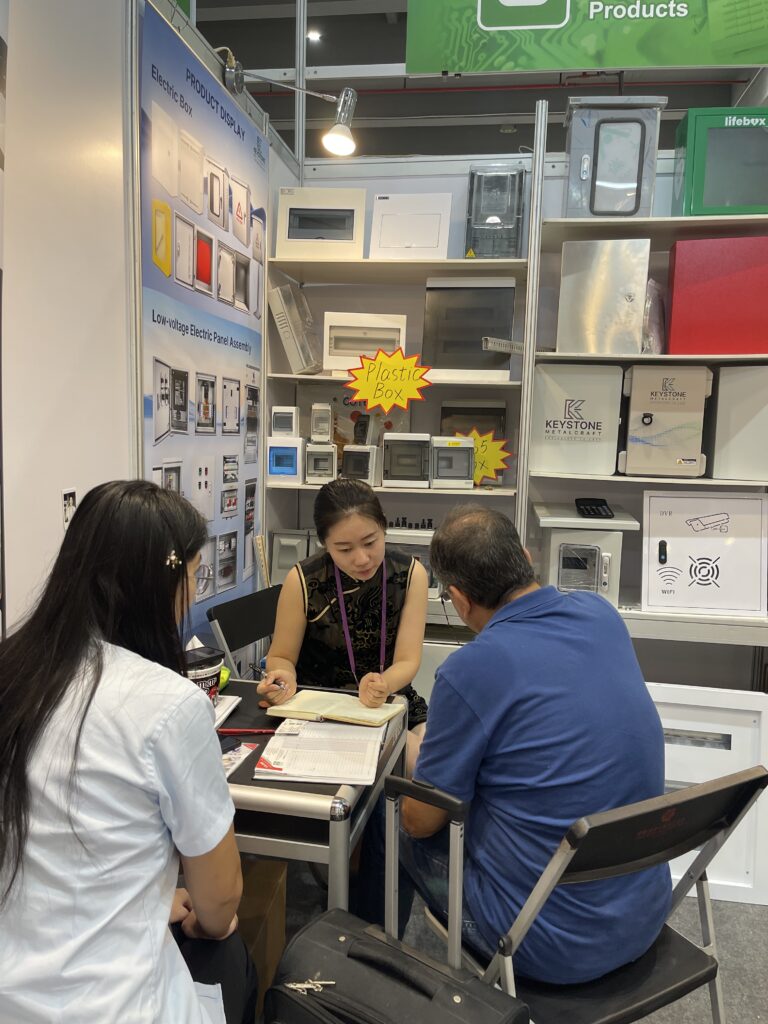 Trade Show Booth Meeting Discussing Product Samples